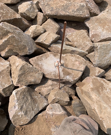 A picture containing rock, outdoor, building, pile

Description automatically generated