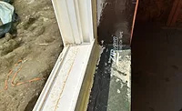 Self-adhered membrane turning into the rough opening to tie in with the interior air seal.