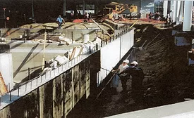 Workers apply a waterproof coating to a wall