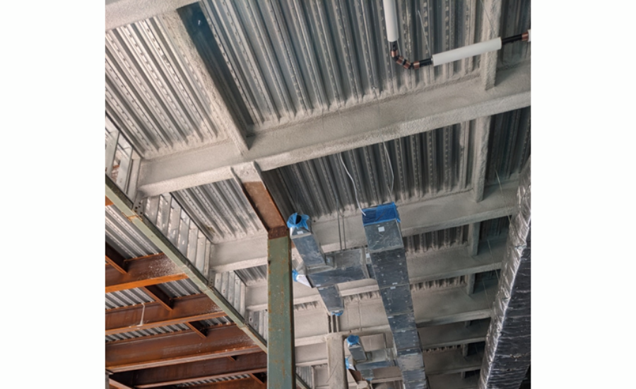 Steel beams with cementitious SFRM partially installed