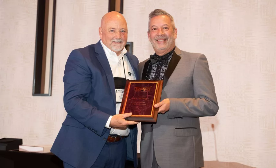 Rick Montoya Accpeting an Award from SPRI
