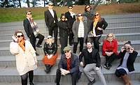 A group of architects gather on stairs