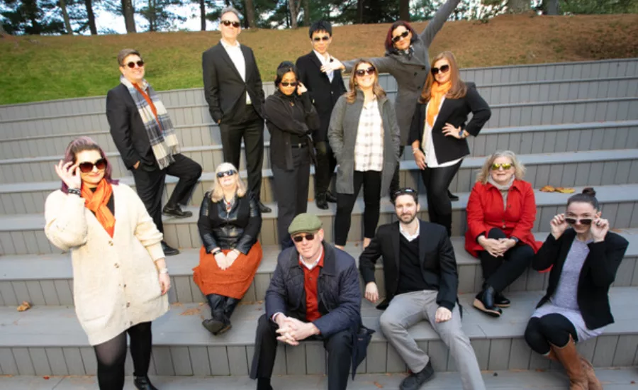 A group of architects gather on stairs