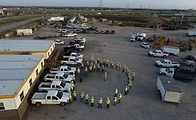construction workers stand outside of the building 