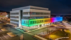 The exterior of 103 CityPoint lit up in rainbow colors