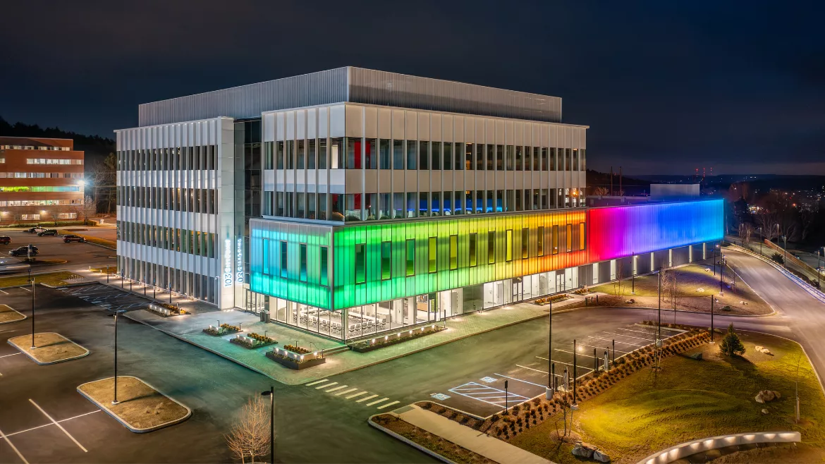 The exterior of 103 CityPoint lit up in rainbow colors