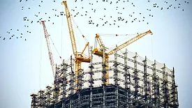 low-angle-photography-of-cranes-on-top-of-building