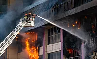 firefighters putting out a fire in a building