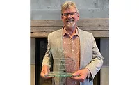Steve Gusterson holds his award