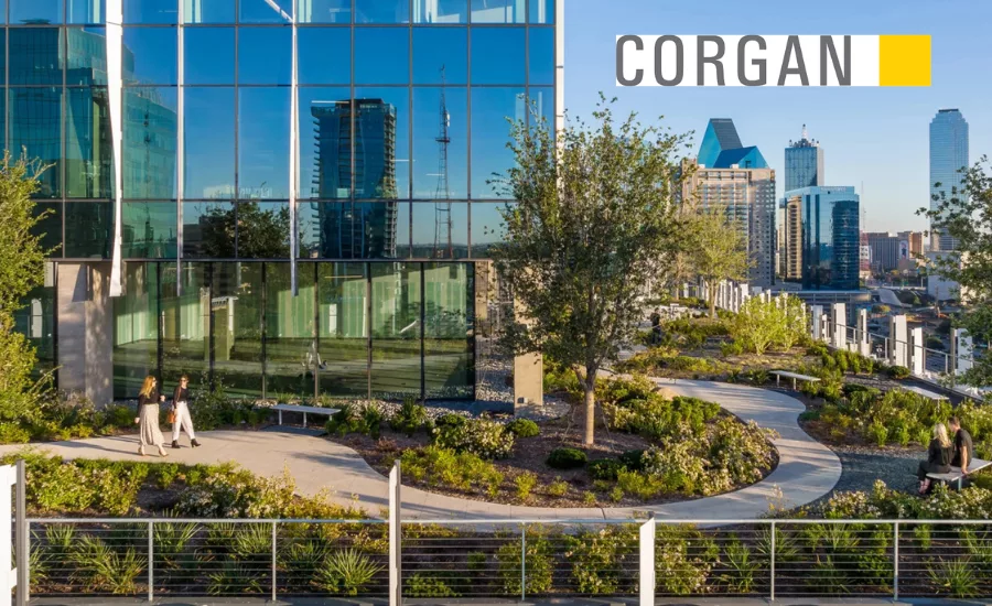 Corgan logo ontop of a city landscape