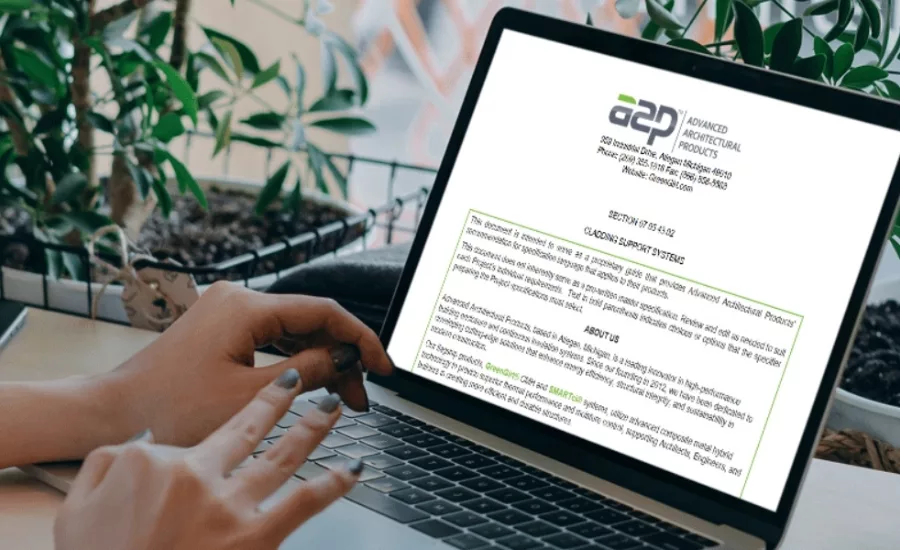 someone types at a computer with an image of a blog template
