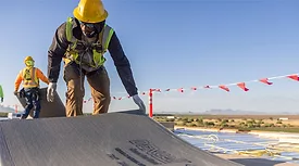 A construction worker using DEXcell roof boards