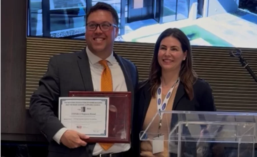 Andrew Irvine, director of product line management for TYPAR, accepts the 2026 Spark Award from Becky Gjerde, Chairman of the LSC Spark Award Committee.