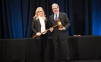 2026 PCI Chair Cheryl Lang receives the ceremonial gavel from outgoing 2025 PCI Chair Carlos Cerna.