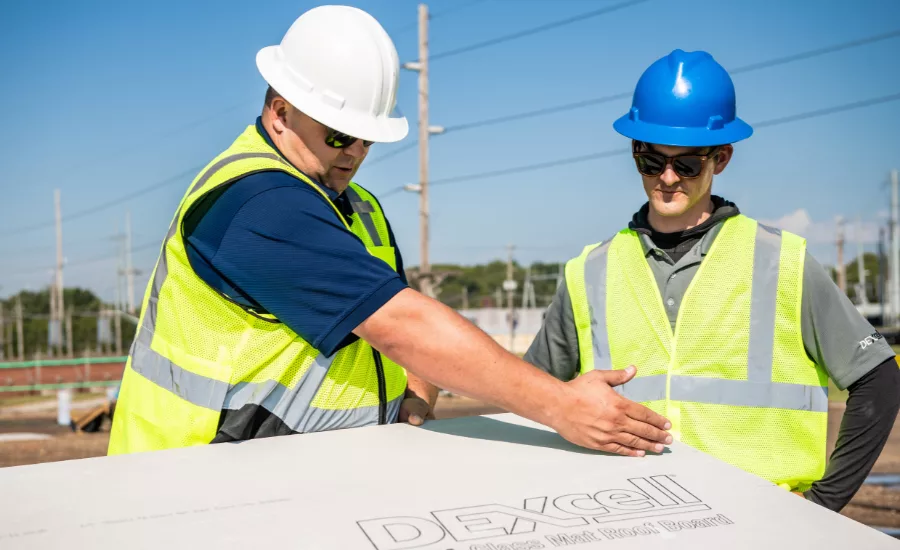 2 construction workers and a DEXcell panel