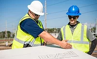 2 construction workers and a DEXcell panel