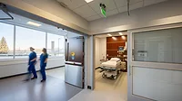 Patient room doors with flexible privacy features widens possible uses within these spaces and improves patient comfort