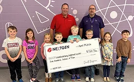 Two men stand behind eight children holding an oversized check
