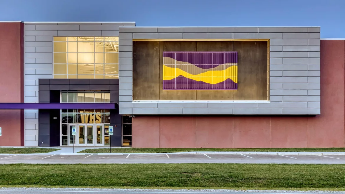 Williamsville-Sherman CUSD #15 exterior shows Painted, perforated panels in purple and yellow