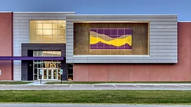 Williamsville-Sherman CUSD #15 exterior shows Painted, perforated panels in purple and yellow