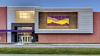 PAC CLAD.png Williamsville-Sherman CUSD #15 exterior shows Painted, perforated panels in purple and yellow