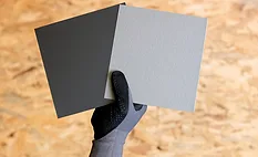 RHEINZINK-GRANUM EXTRA samples held up by a gloved hand