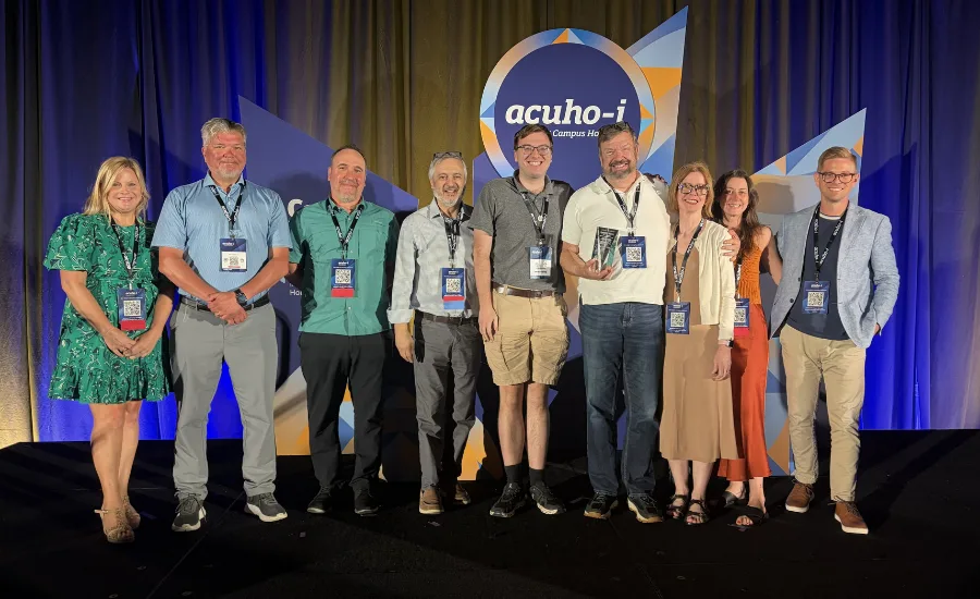 Members of Lawrence Group's student housing team and family turned out to celebrate Paul Wuennenberg's ACUHO-I Parthenon Award. The group poses with award winner.
