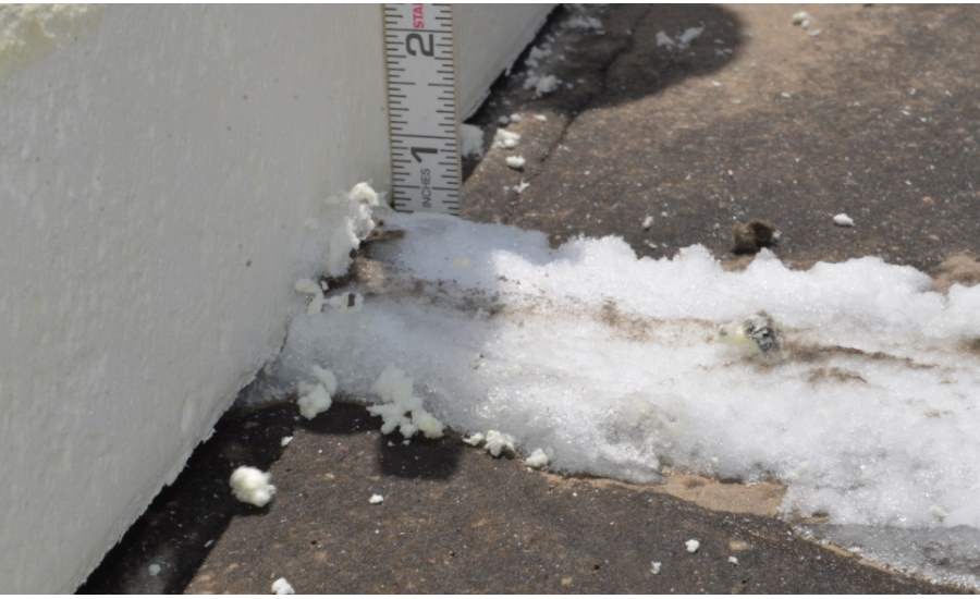 Shown is ice buildup between rigid insulation boards in the roof of a cold storage building.