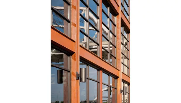 A sculptural, vertical element resembling the hull of a barge acknowledges the site's heritage. 
