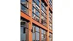 A sculptural, vertical element resembling the hull of a barge acknowledges the site's heritage. 