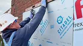 Worker on New Western Facade.jpg