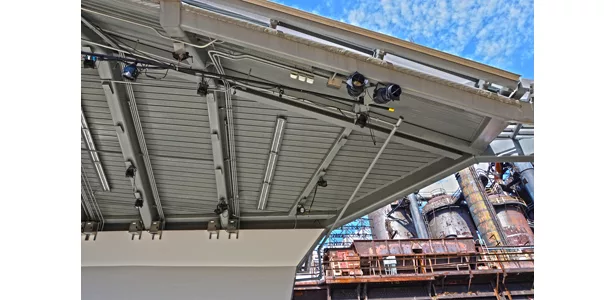 This detail of the pavilion shows the acoustical steel deck that supports the waterproofing with several visible upside down T-sections for the rigging connections.