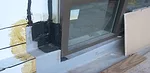 The transition detail at the jamb/sill of the terrace curtain wall system.