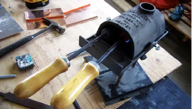 A commonly used soldering irons: hand coppers with propane pot.